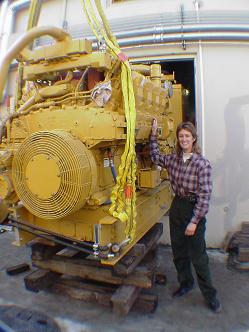 CAT 3412 diesel standby emergency generator being craned into the engine room of a northern California telecommunications facility.