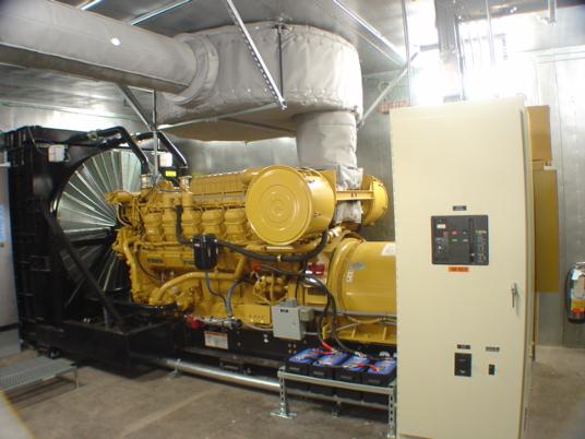 1100 kW Caterpillar 3512B standby emergency generator installation with hockey puck super critical silencer.